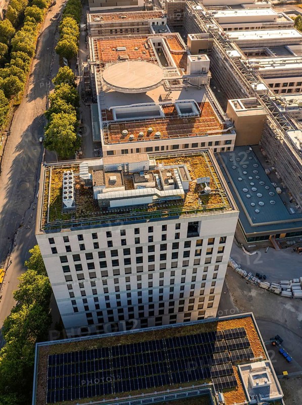Modern buildings with green roofs and solar panels in an urban landscape with trees, airfield, Böblingen, Germany