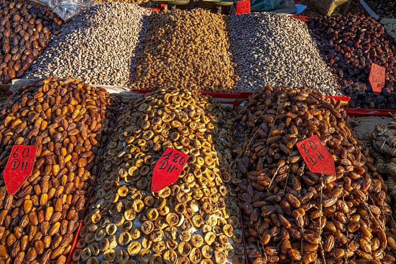 Various dried dates, figs, pistachios, nuts and almonds are on display for sale at a sales stand, souk, bazaar, Marrakech, Maghreb, Morocco, North Africa