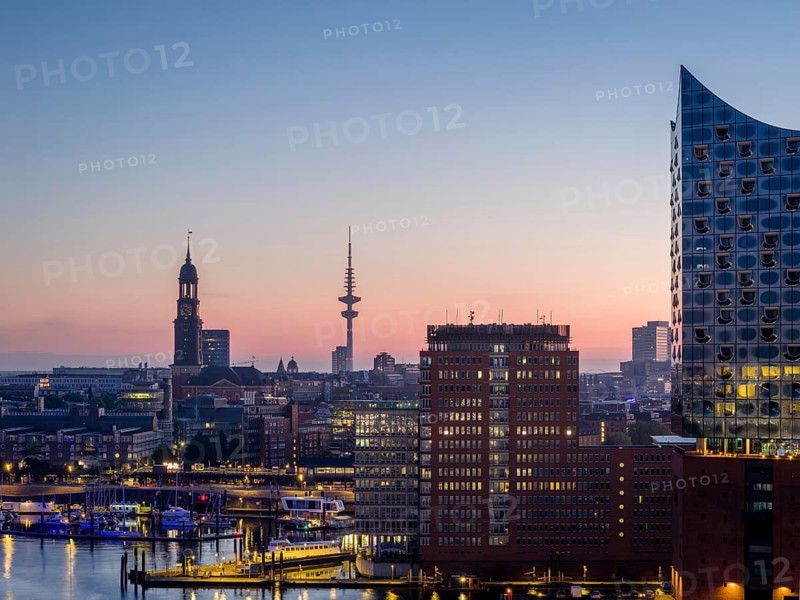 Aerial view of the sunrise on the Elbe with Elbe Philharmonic Hall, St Michael's Church (Michel) and Heinrich Herz Tower, Hamburg, Germany