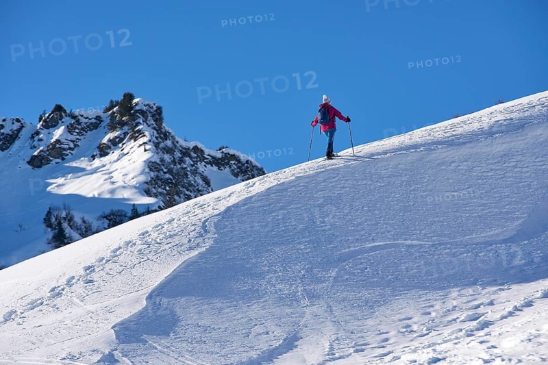 Woman hiking with snow shoes in the Kleinwalsertal, Vorarlberg, Austria