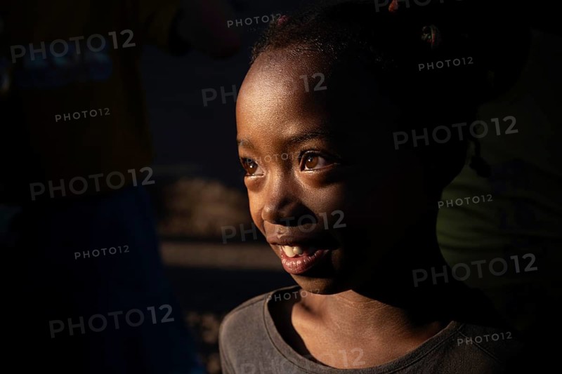 Portrait of a girl at the weekly market market in Ambalavao with light accents on her face