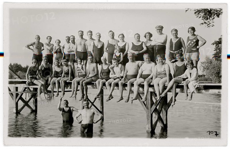 Bathing, swimwear, woman, men, children, leisure, fun, summer, jetty, lake, large group in bathing suits sitting on a wooden walkway over water, around 1926