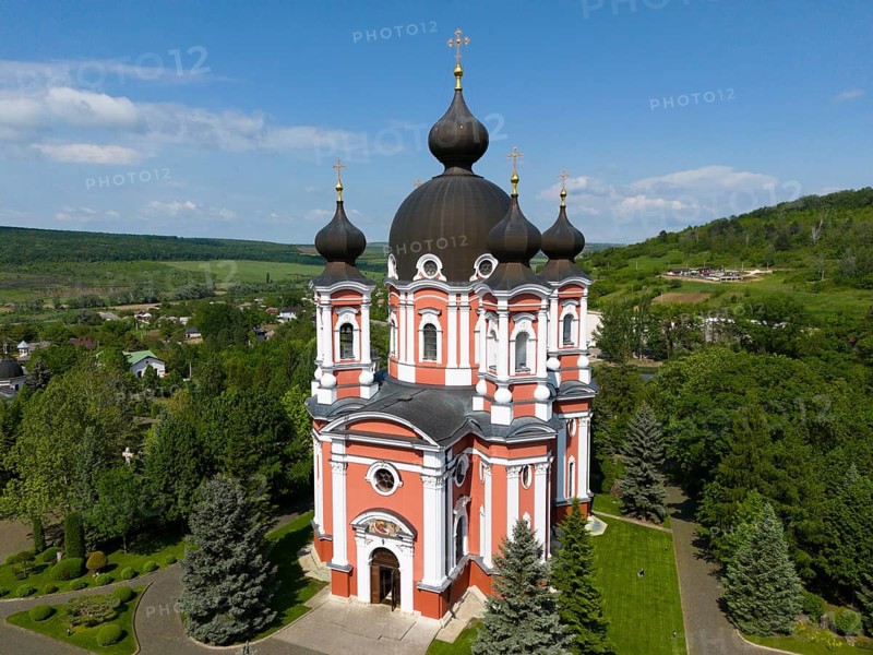 Magnificent orthodox cathedral with black domes surrounded by lush nature and blue sky, aerial view, Cathedral of the Nativity of the Virgin Mary, Curchi monastery, Orhei district, Republic of Moldova, Moldova