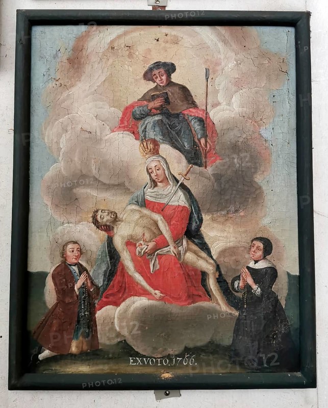 Votive image from the 18th century in the monastery church, Mönchsdeggingen monastery, former monastery of the Mariannhill missionaries, near Nördlingen on the southern edge of Riesrand, Donau-Ries district, Swabia, Bavaria, Germany. Depiction of Pieta, the Mother of God, holding the body of her son Jesus Christ on her lap. A sword penetrates her chest. Saint Jodok is enthroned in the clouds above the Pietà