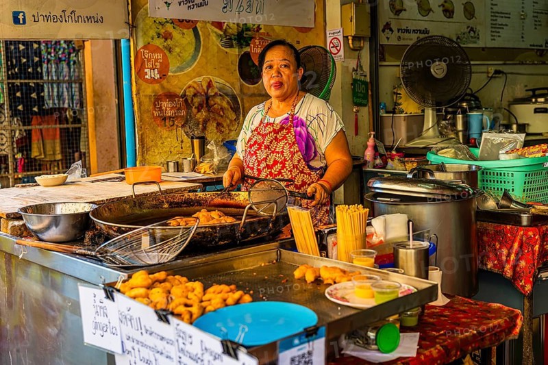Chef preparing lard pastries in an open kitchen, Kad Luang Warorod Market, Chiang Mai Thailand