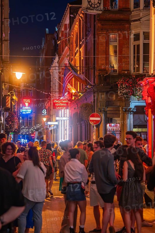 Lively night atmosphere with a large crowd on an illuminated street, nightlife, Dublin, Ireland