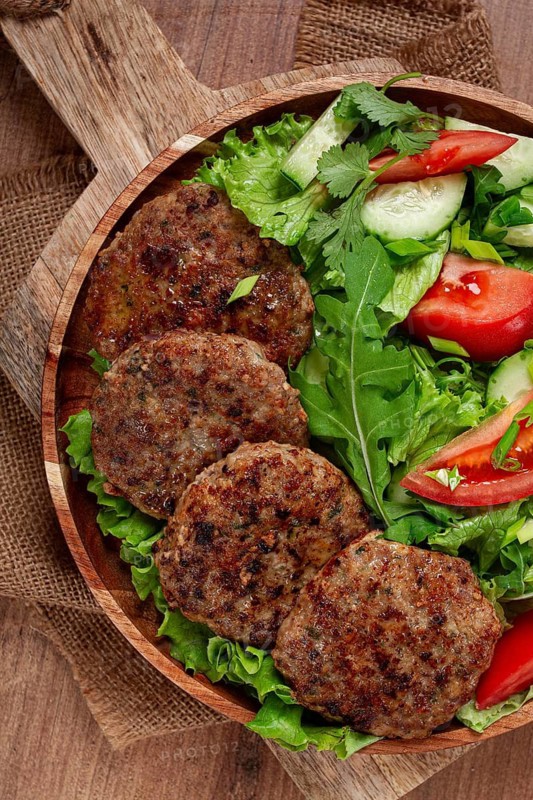 Fried cutlets, mixed minced meat, with vegetable salad, homemade, top view, no people