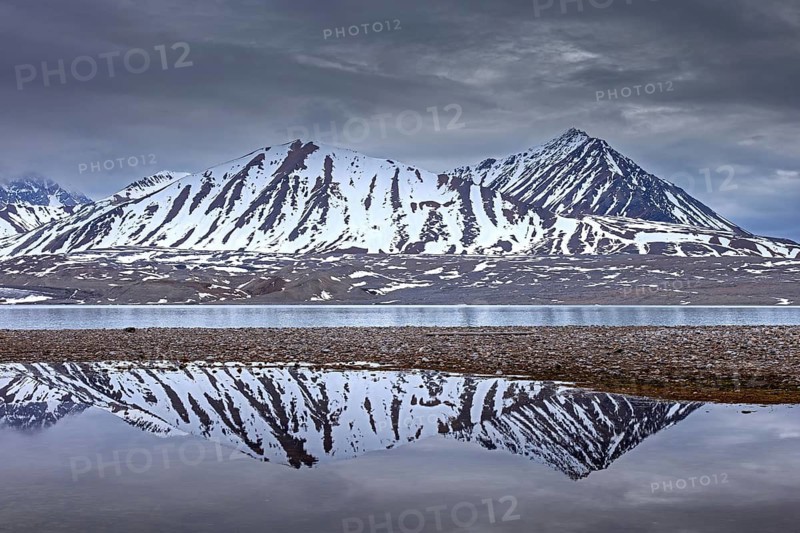 Reflection of mountains in lake near the Fjortende Julibreen, 14th of July Glacier in spring, Haakon VII Land, Spitsbergen, Svalbard, Norway