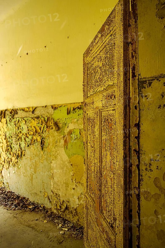 Old paint peeling off a door in thick flakes, former lung hospital and lost place Heilstätte Grabowsee, Oranienburg, Brandenburg, Germany