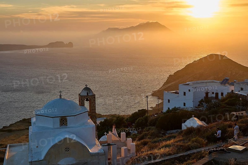 Panagia of Thalassitra church, Panagia Thalassitra, sunset over the sea with a view of a church and silhouette of an island in the background, Plaka, main town on Milos, island of Milos, volcanic island, Cyclades, Greek islands, Greece