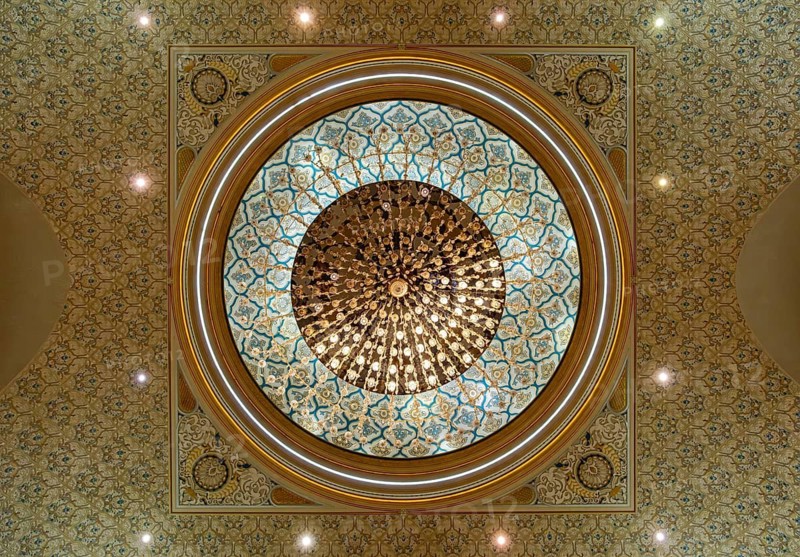 An upward view of a crystal chandelier hanging from the intricately decorated geometric dome, Qasr Al Watan Presidential Palace, Abu Dhabi, UAE