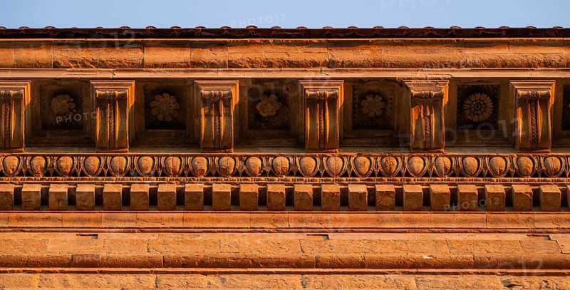 Detailed view of the intricately crafted roof cornice of Palazzo Strozzi, warm evening light, old town, Florence, Tuscany, Italy