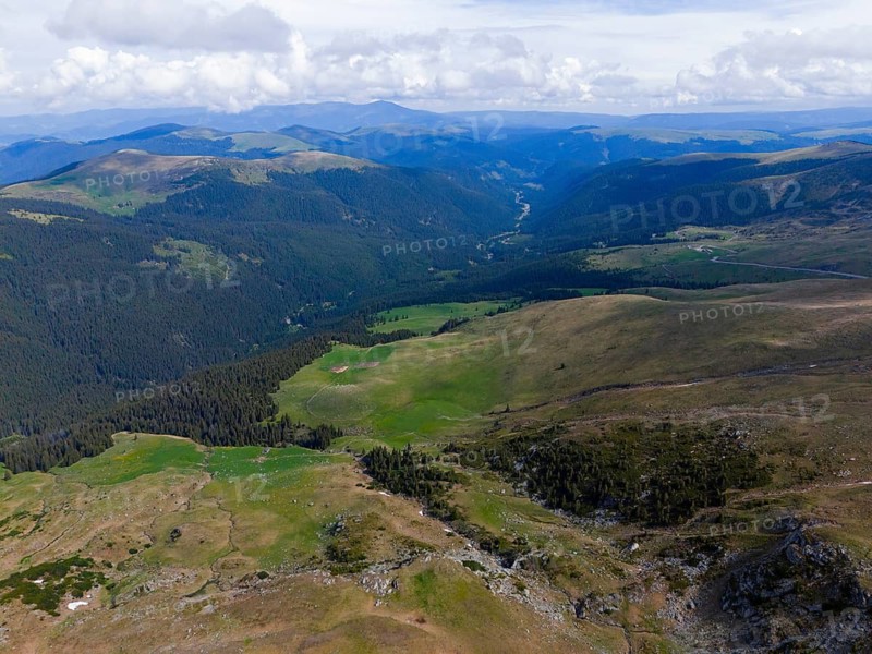 View of a wide valley with forests and mountains on the horizon under blue sky, aerial view, Transalpina High Road, Drum na?ional 67C, National Road, Transylvania Alps, Southern Carpathians, Romania