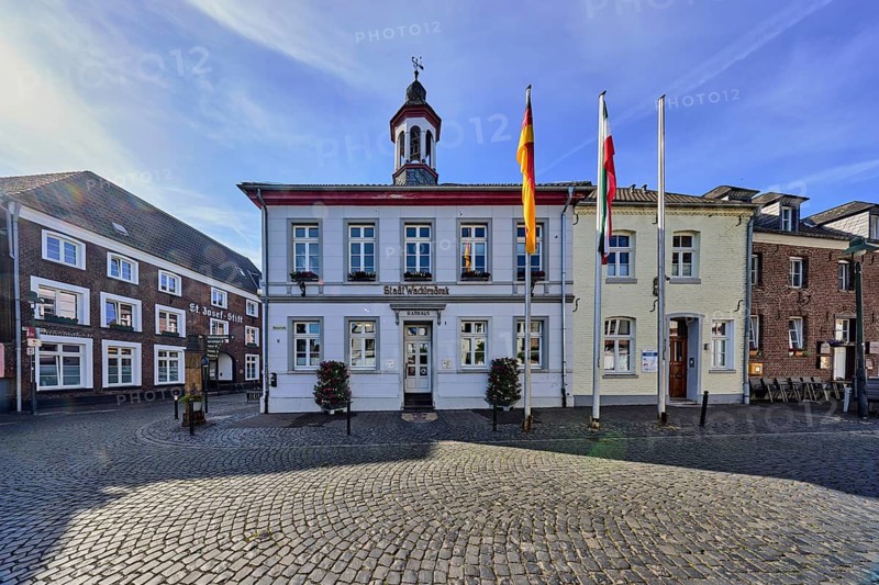Town Hall, Old Town, Historic City Center, Historic Buildings, Street, Flag Poles with Flags, Street, Paving Stones, Side Light, Blue Sky, Cirrus Clouds, Wine Route Junction with Feldstraße, Wachtendonk, Kleve District, North Rhine-Westphalia, Germany