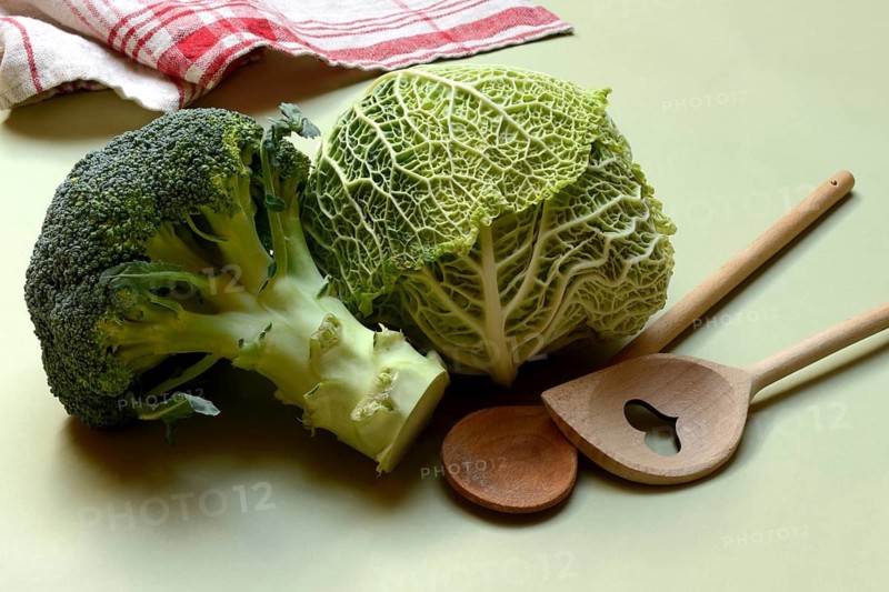 Savoy cabbage and broccoli with cooking spoon