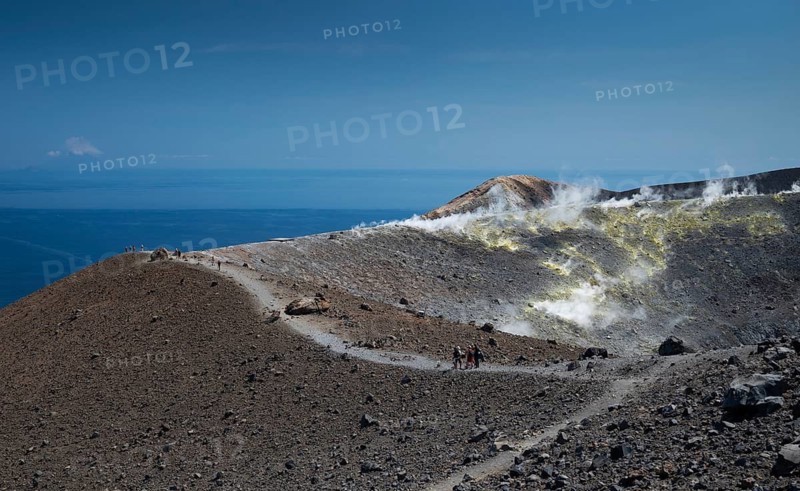 Visitors walk along the crater rim, sulfur vapors rise, in the background the Mediterranean Sea, Vulcano, Aeolian or Aeolian Islands, Sicily, Southern Italy, Italy