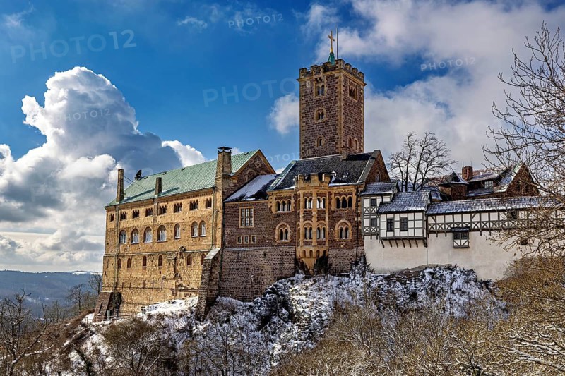 Castle with towers in snow under dramatic sky, medieval architecture, The Wartburg near Eisenach in Thuringia