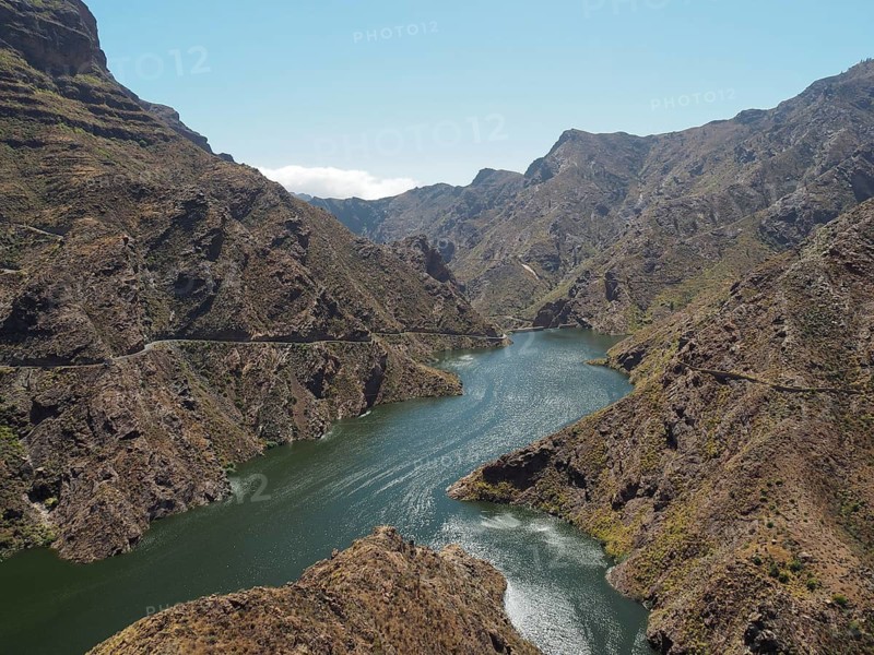 Mountain valley with a large reservoir under a clear sky, Presa del Parralillo, Gran Canaria, Spain
