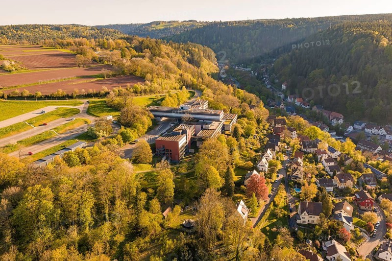 Extensive panoramic view of a village with surrounding forests and hills in an evening atmosphere, Calw District Office, Calw District, Germany