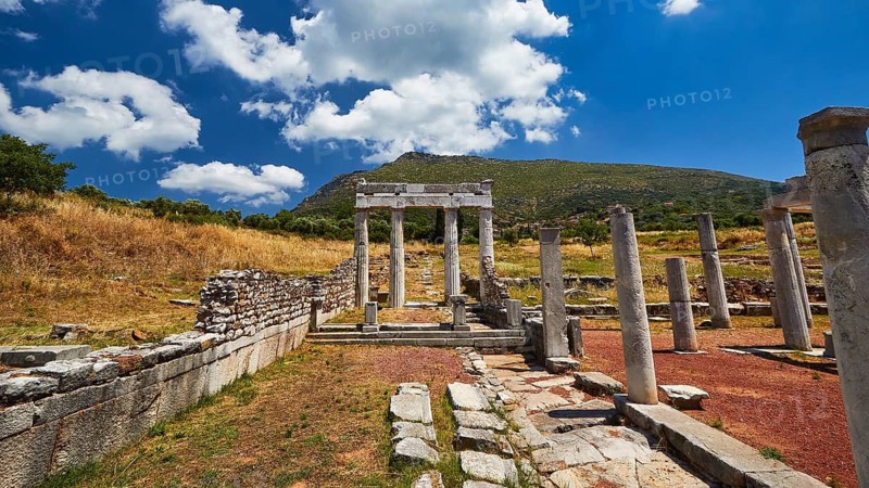 Columns next to the stadium, ancient ruin landscape with remains of columns and mountains in the background under blue sky, ancient site, archaeological site, Messene, Messini, Messinia, southwest of the Peloponnese, odyssey, Odyssey, Odysseus, Ulysses, film, filming location, Matt Damon, Peloponnese, peninsula, Greece