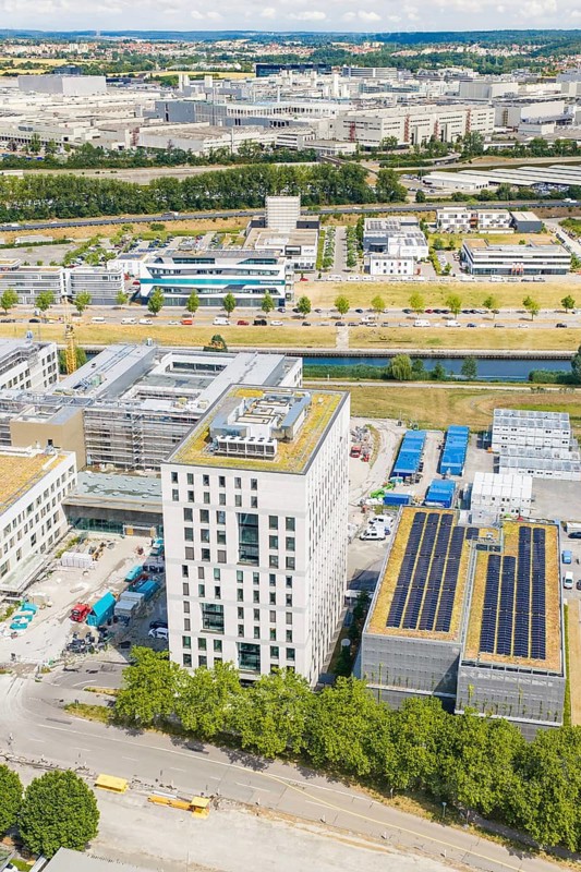 Commercial building with solar panels in a commercial area surrounded by green spaces, airfield, Böblingen, Germany