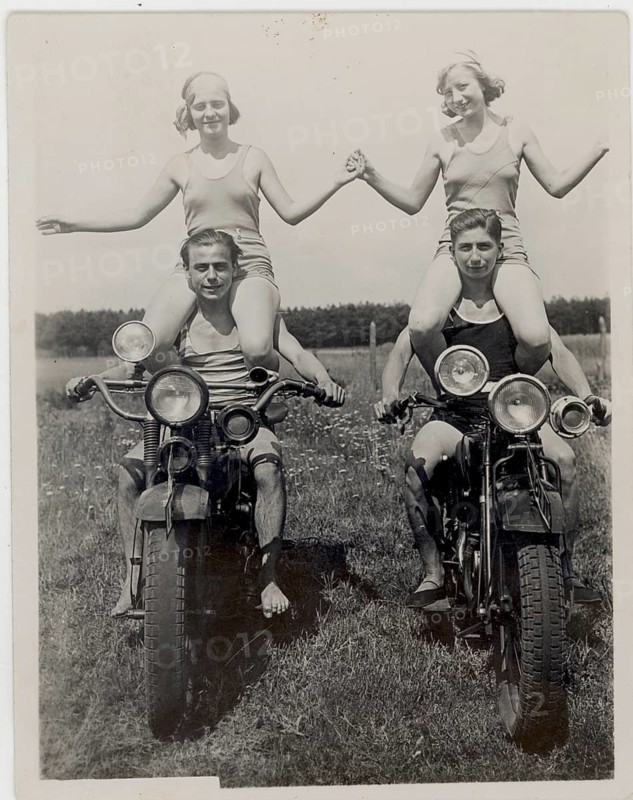 Bathing, swimwear, leisure, summer, fun, two woman sitting on the shoulders of men on motorbikes, all laughing, around 1930