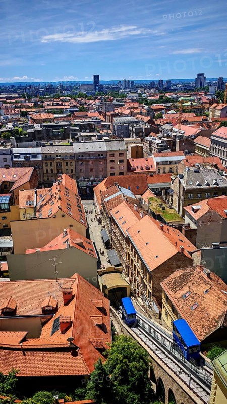 Panoramic view from Lotrscak Tower over the old town of Zagreb with red roofs and a cable car going down a road, Zagreb, Croatia