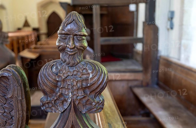 Carved wooden poppyhead face of man with beard, village parish church of Saint Andrew, Winston, Suffolk, England, UK
