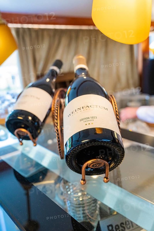 Two wine bottles in elegant holders in a stylish and well-lit restaurant, Schifffahrt, Neckar, Wilhelma, Stuttgart, Germany