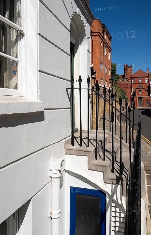 Details of a building with stairs and lattice door, narrow street lined with historic brick buildings, quiet residential area, Chelsea, London, Great Britain, England, Great Britain