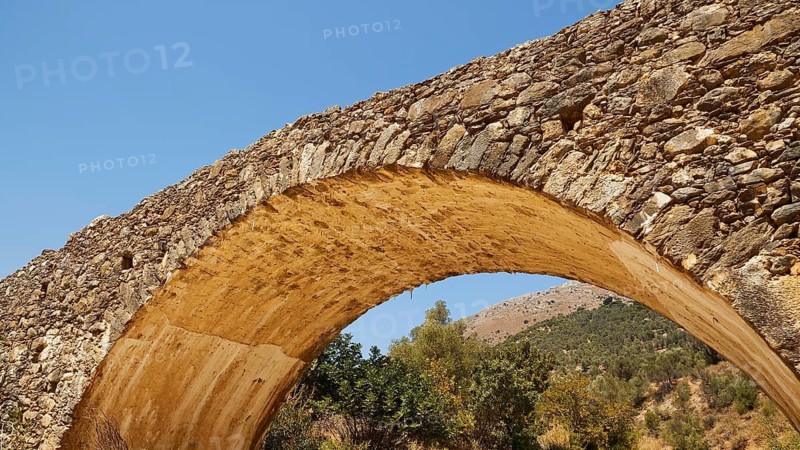 Old stone bridge with arch against natural background, Amari Basin, Amari, Central Crete, Greek Islands, Greece