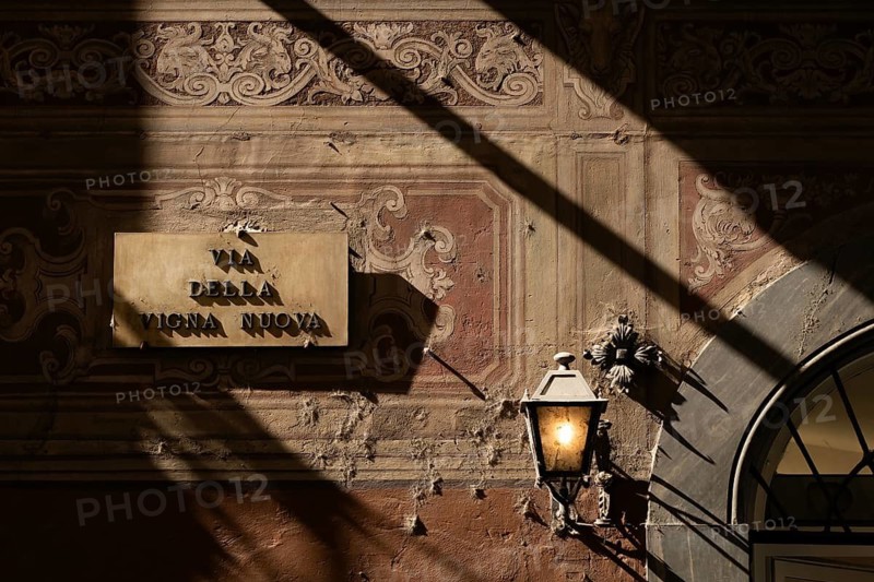 House wall painted with arabesques, street light, shadow, Florence, Tuscany, Italy