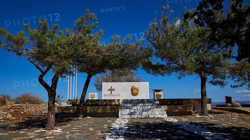 Memorial to Greek cadets who opposed the German soldiers in May 1941, memorial surrounded by trees under a clear blue sky, Rodopou Peninsula, Rodopou, West Crete, Greek Islands, Greece
