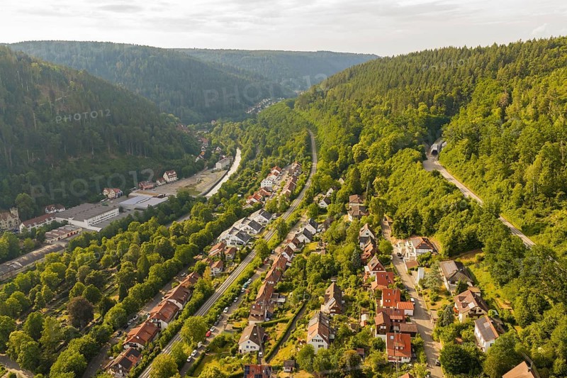 A village in a green valley with houses and tracks, surrounded by forest, Hermann Hesse Railway, Calw, Germany
