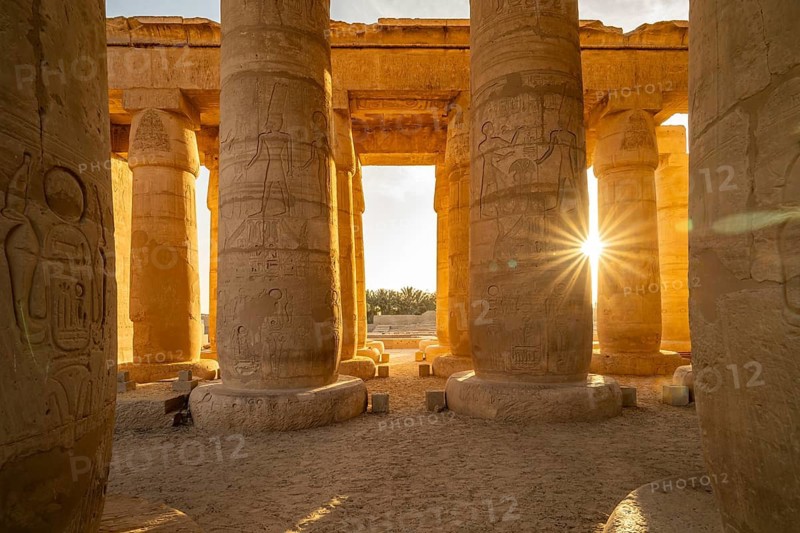 The sun between the pillars of Ramesseum, mortuary temple of Ramesses II in the Theban necropolis near Luxor, Egypt