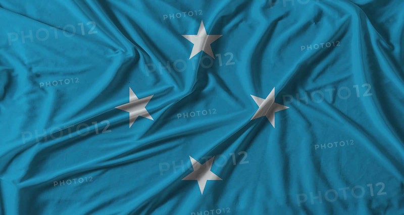 Micronesia flag with fabric texture background. National flag of Micronesia with cloth texture