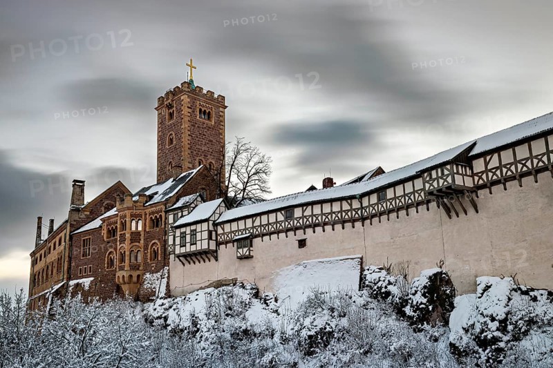 Wintery castle with snow-covered tower and timbering under cloudy sky, The Wartburg near Eisenach in Thuringia