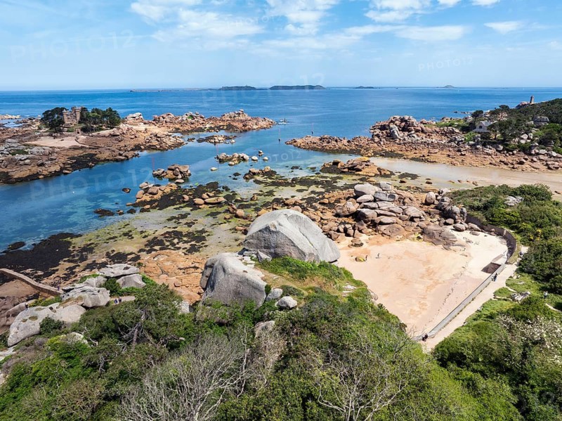 Aerial view of the picturesque coastal landscape on the Pink Granite Coast with the neo-Gothic Château de Costaérès on an island at low tide, Ploumanac'h, Perros-Guirec, Trégastel, Côtes-d'Armor department, Brittany region, France