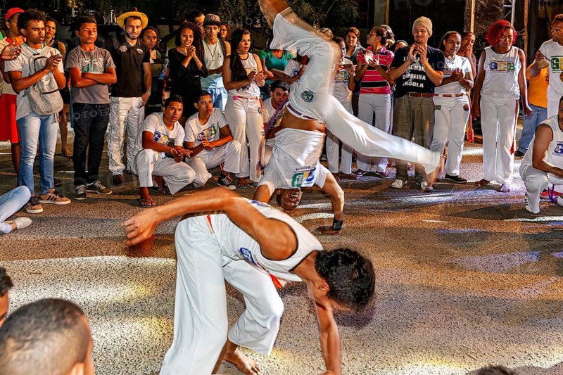 Capoeira is shown in a lively environment through impressive flips and movements, The Capoeira combat dance at a small festival in Petrolina Brazil