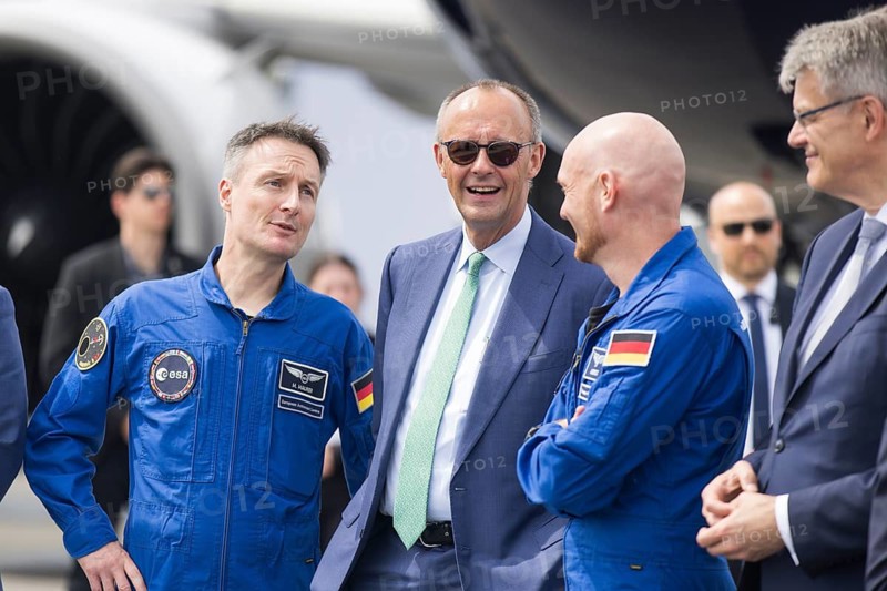 Friedrich Merz (Chancellor of the Federal Republic of Germany, CDU, wearing sunglasses) chats with the two German astronauts Alexander Gerst and Matthias Maurer at the ILA (International Aerospace Exhibition) on 10 June 2026 at the Berlin-Schönefeld Exhibition Centre