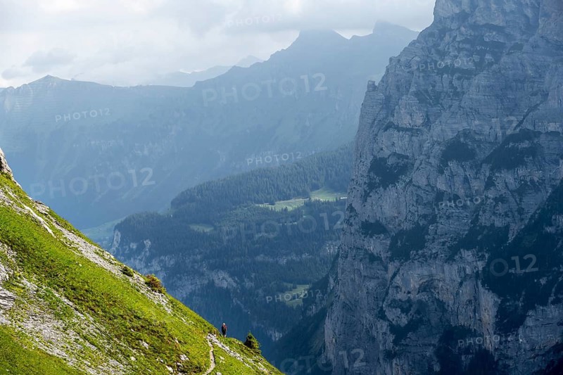 Hiker on a steep hiking trail, Bernese Alps, Bernese Oberland, Switzerland