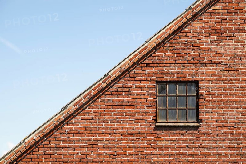 Roof and wall with latticed window, old brick house, farm, Sortebærdalen Strand, Houvig, North Sea, Denmark