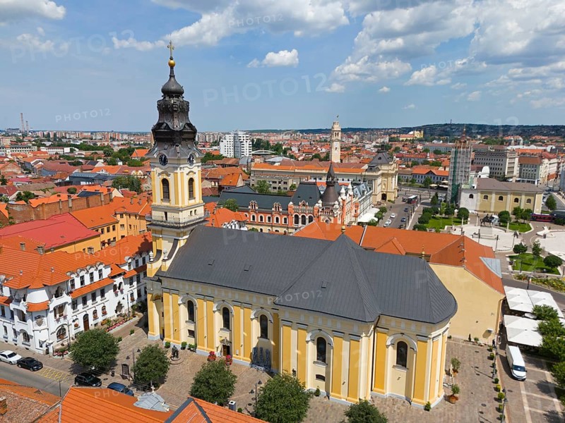 Baroque church with red roofs in the midst of an urban landscape, surrounded by cloudy sky, aerial view, St. Nicholas Church, Oradea, Oradea, Bihor district, Kreisch region, Kreischland, Transylvania, Romania