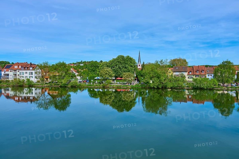 Idyllic reflection of houses and a church in the calm water of a river, Main, Veitshöchheim, Würzburg district, Spessart, Mainfranken, Lower Franconia, Bavaria, Germany