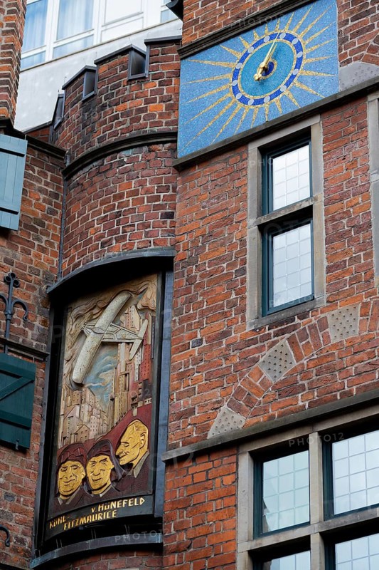 Three times a day, the carillon rings out in the historic Böttcherstrasse, a panel depicting figures between the Carillon House and the Roselius House (left), Captain Hermann Köhl, Colonel James C. Fitzmaurice, Ehrenfried Günther, Baron von Hünefeld, the old town of the Hanseatic City of Bremen from the 1920s, an example of Klinker Expressionist architecture, artistic design, brick architecture, a popular tourist destination, Germany