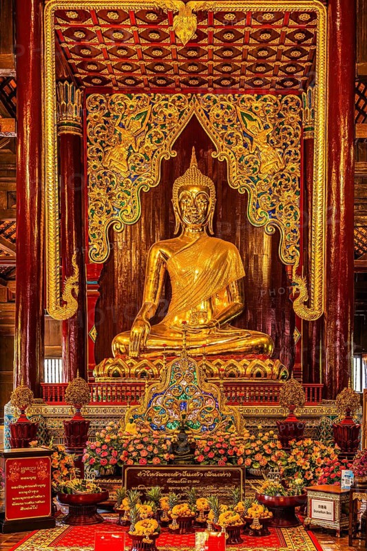 Gilded seated Buddha figure in a public prayer room, Wat Phra Singh Buddhist temple complex, Old City Center, Chiang Mai, Thailand
