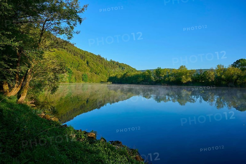 Wooded slopes are reflected in a quiet river on a clear morning, Boxtal, Main-Boxtal, Tauber-Kreis, Baden-Württemberg, and Stadtprozelten, Dorfprozelten, Main, Spessart, Bavaria, Germany