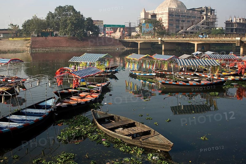 Tourboats moored on a river in Raipur (Chhattisgarh, India) . River name is Kharun. The river is polluted by plastic. The boats are used by the local people for recreation and also by the local hindu people to immerse the ashes of a relative (after a cremation) in the river