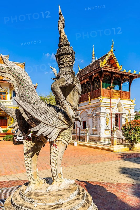 A human and bird-like stone creature in the Buddhist temple complex Wat Chiang Yuen, Chiang Mai, Thailand