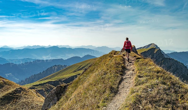 Nice senior woman, hiking in autumn on the ridge of the Nagelfluh chain near Oberstaufen, Allgaeu, Bavaria, Germany